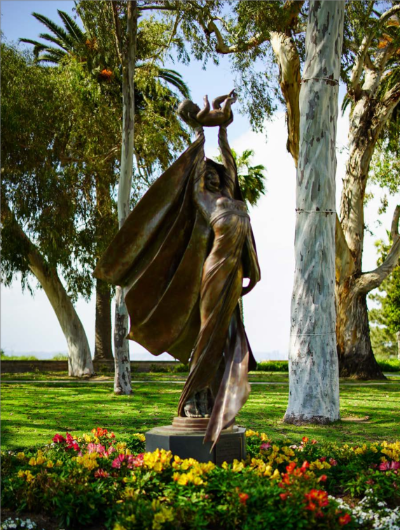 Statue of woman holding baby to the sky